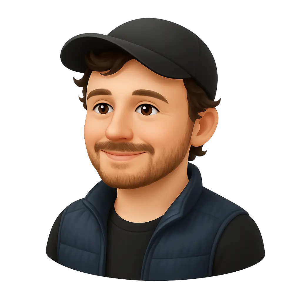 Cartoon avatar of a smiling man with brown hair and beard wearing a black cap, black shirt, and navy blue vest.